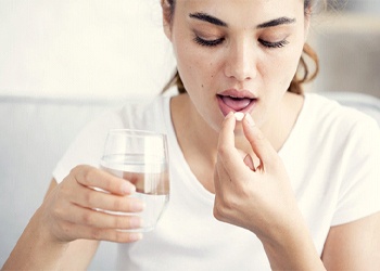 Woman taking pill