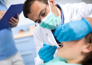 A dentist performing a dental exam.