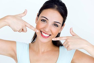 Woman pointing to beautiful smile