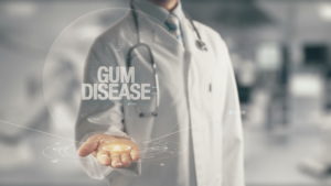 Doctor holding "Gum Disease" Sign